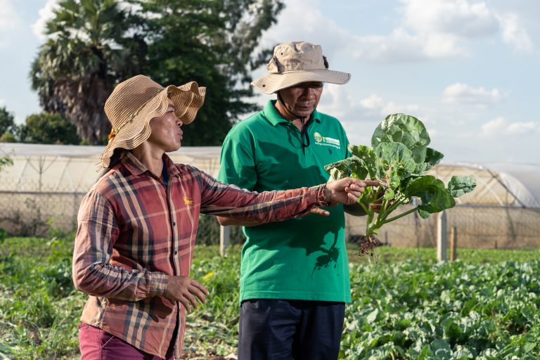 A Plantwise Plant doctor (Right) promoting the benefits of natural biopesticides to a female farmer (Left) in Cambodia
