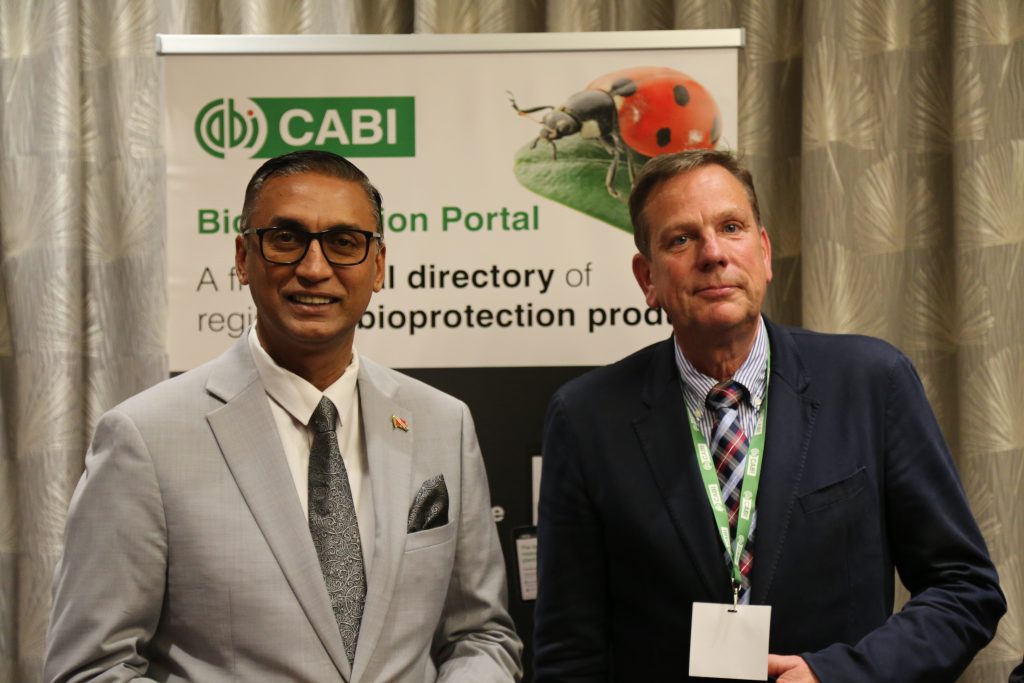 Ulrich Kuhlmann and Ravi Ratiram in front of a cabi bioprotection portal banner.