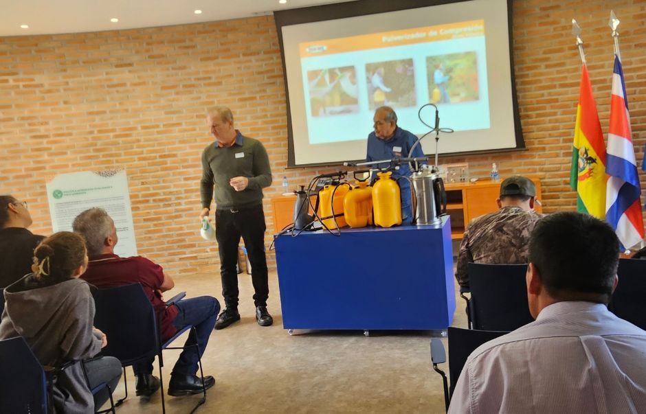 Trainers talking to participants during an agricultural training session.
